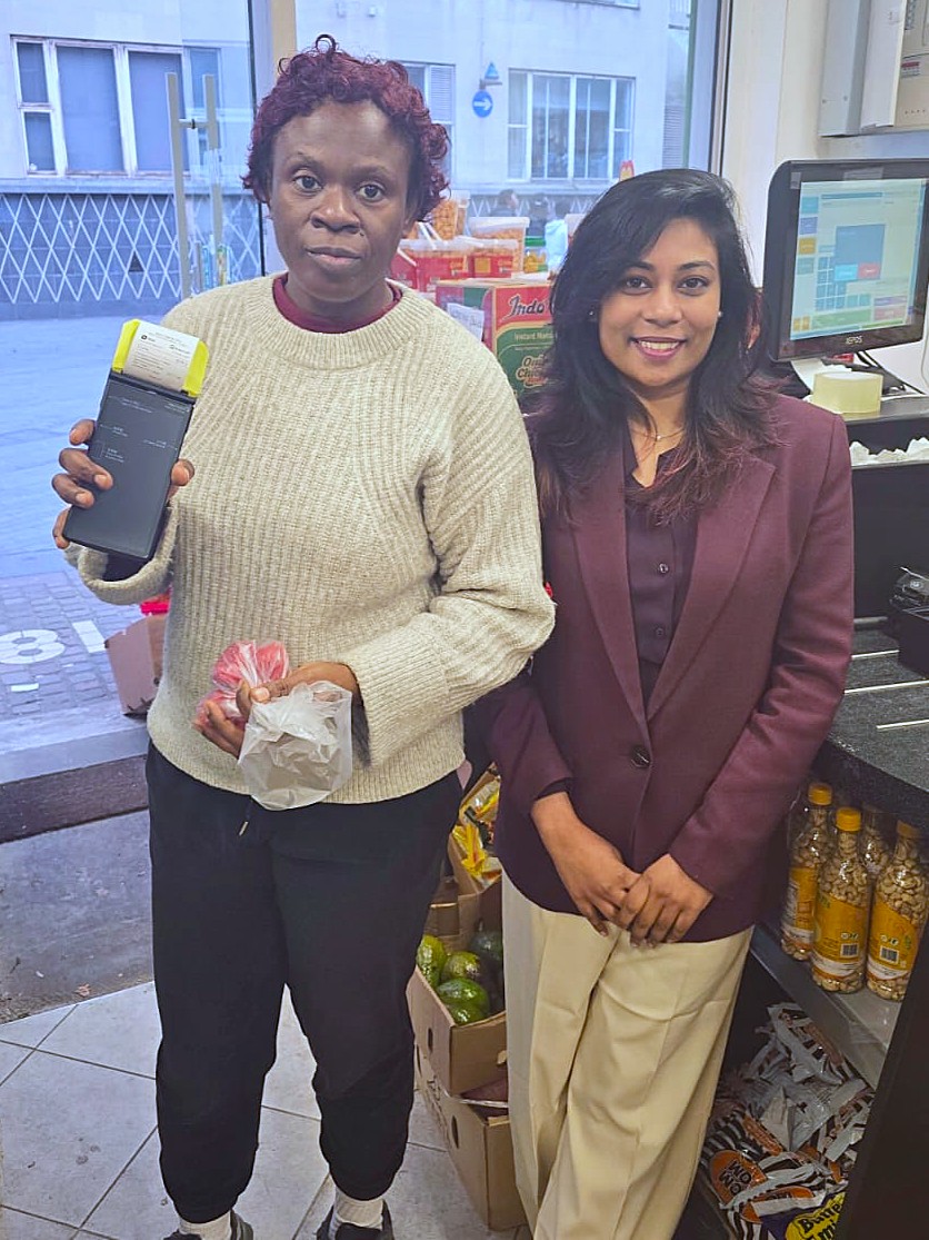 Happy with a convenience store owner beside the EPOS till